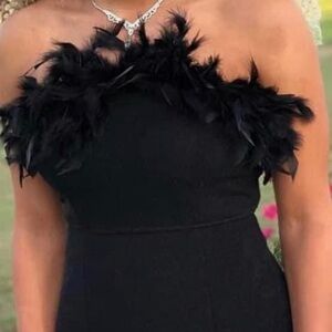 Like new, slit in the side, feathers around the top